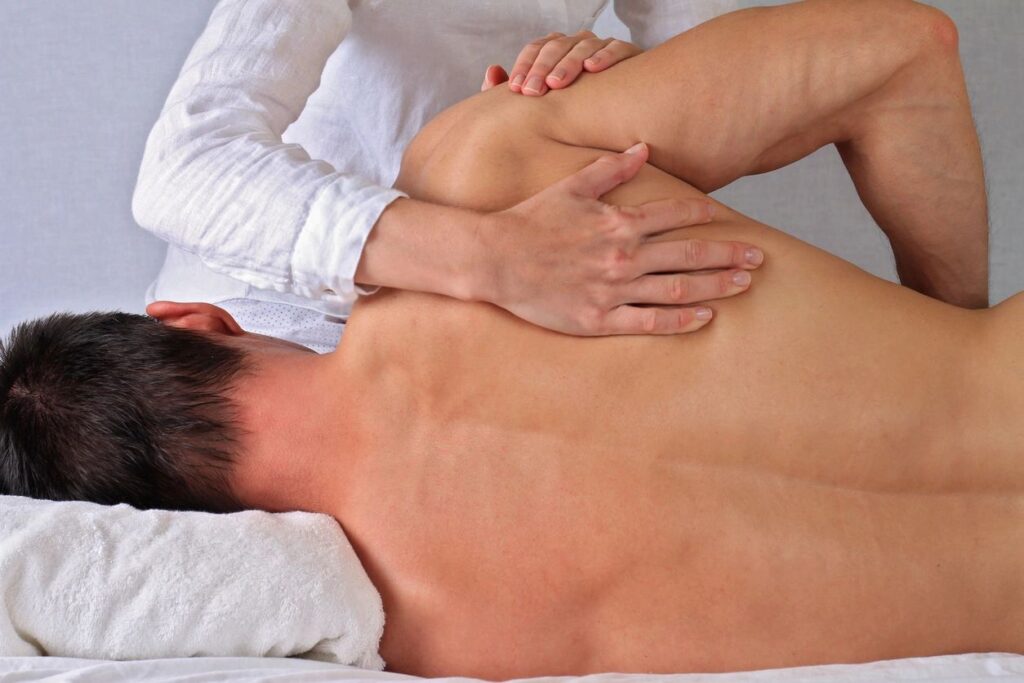 chiropractor working on shoulder pain